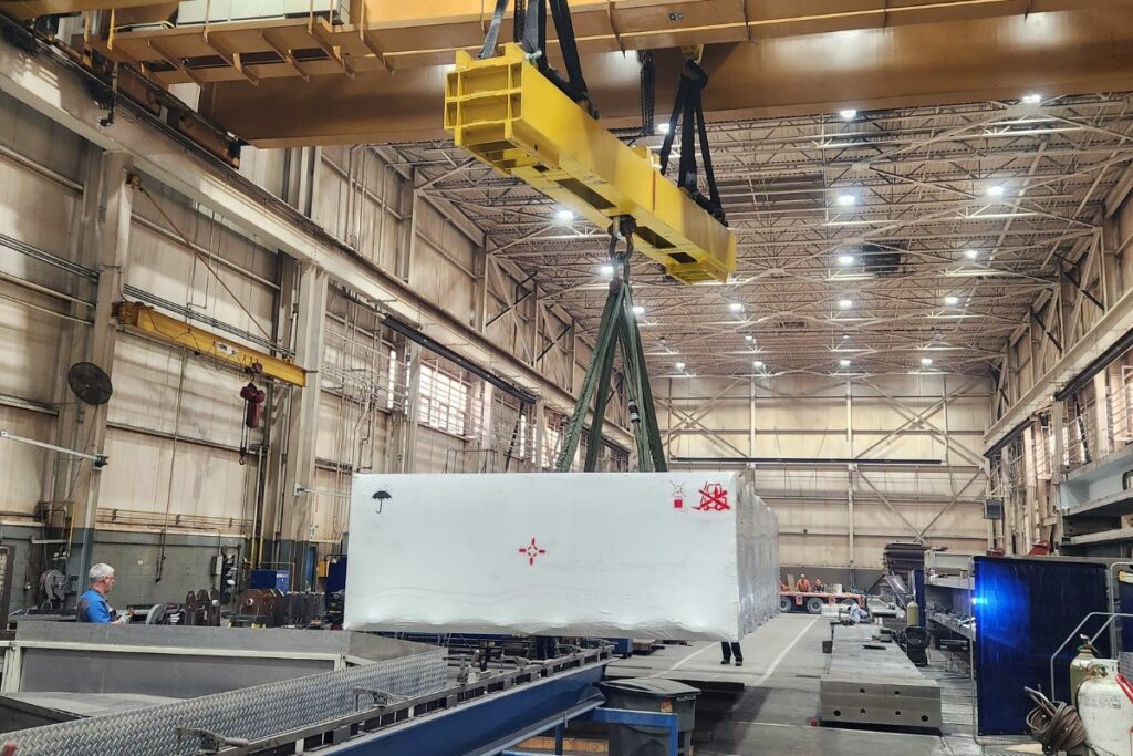 Overhead crane hauling large materials.