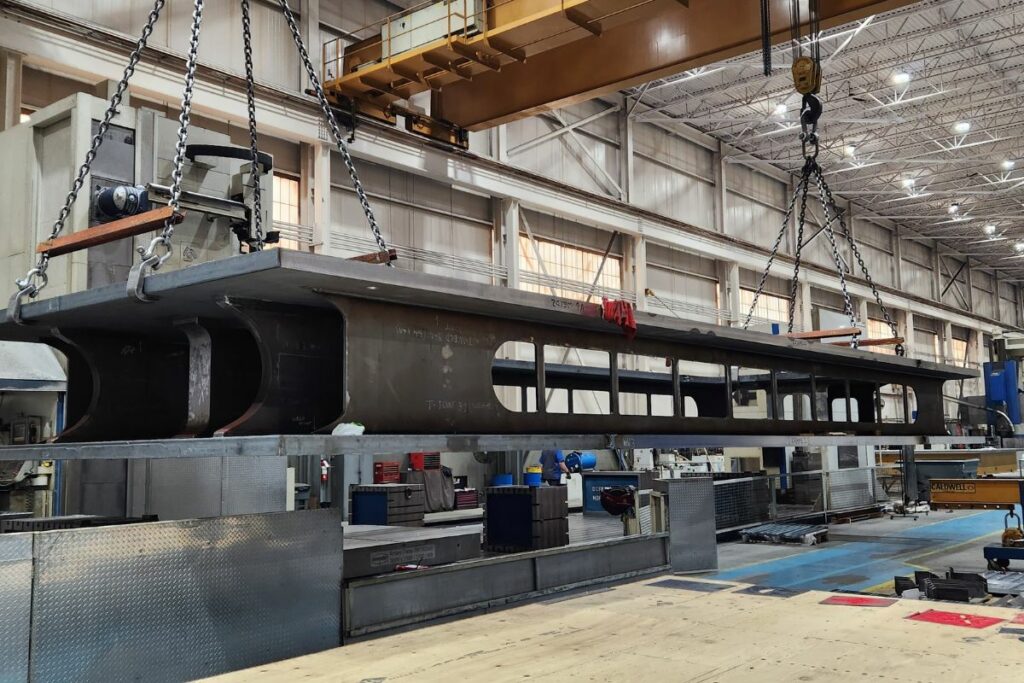 Overhead crane hauling large materials.