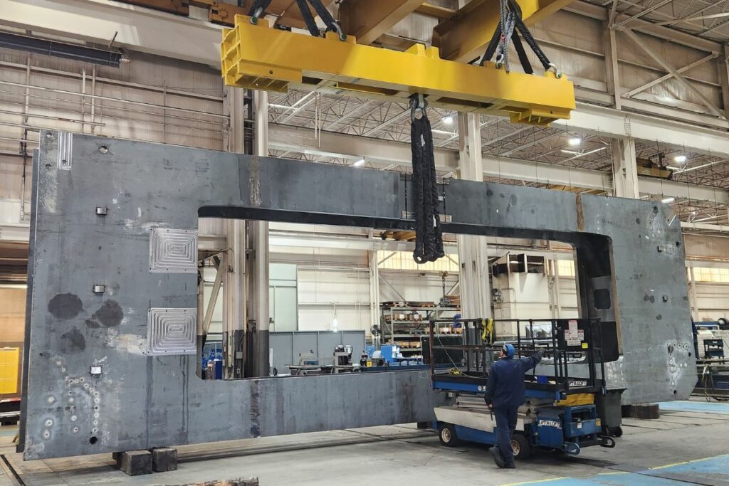 Overhead crane hauling large materials.